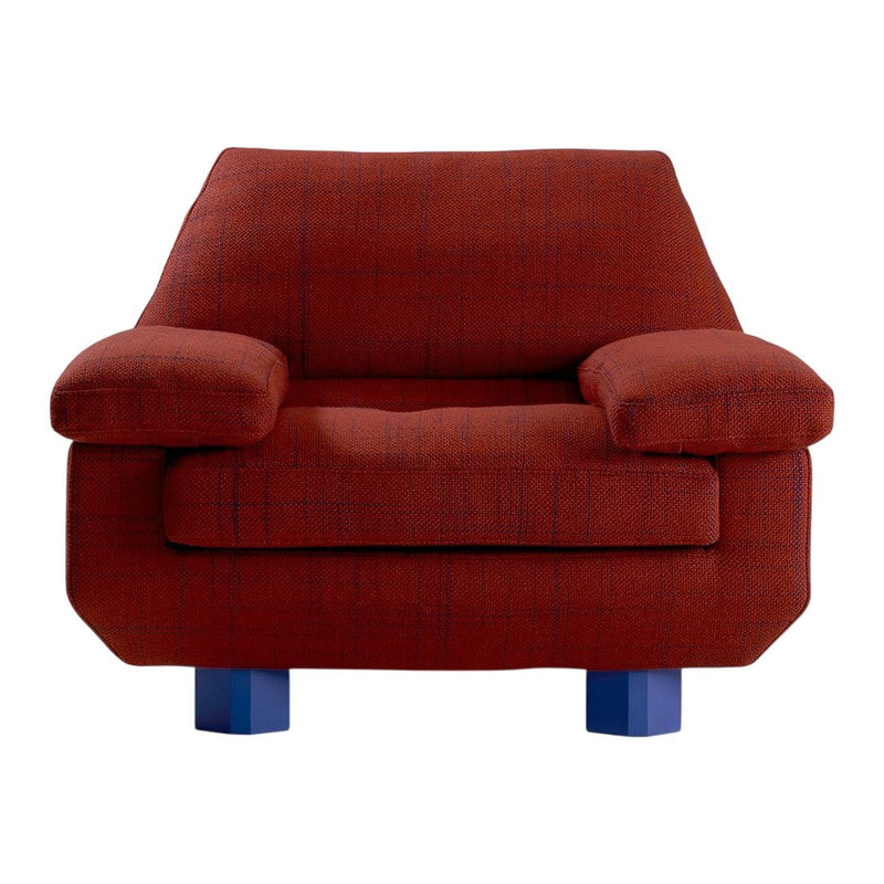 Textured rust-red armchair with blue legs, showcasing a modern geometric pattern. Ideal for stylish living spaces.