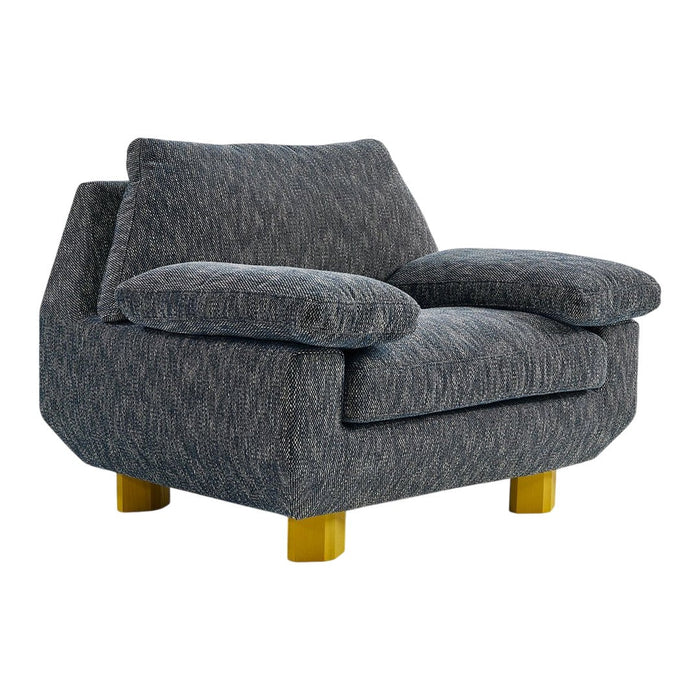 Gray textured armchair with plush cushions and golden wooden legs. Ideal for modern home decor.