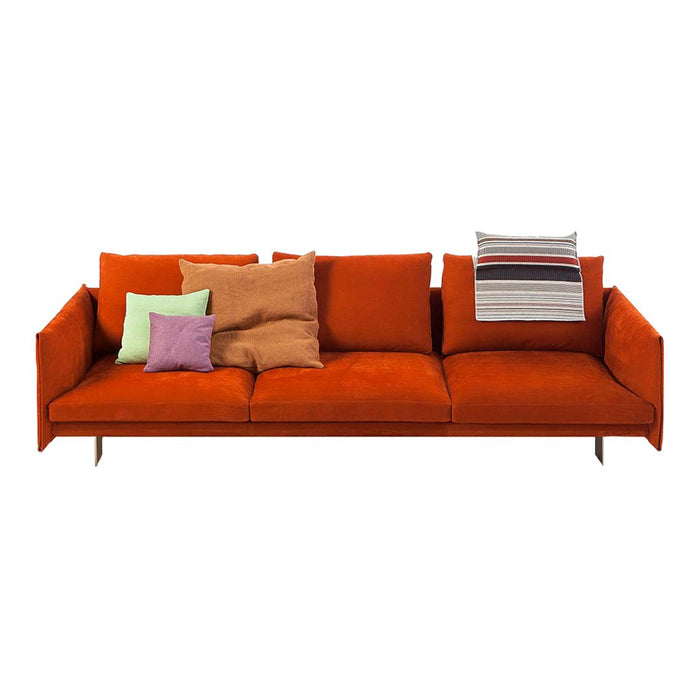 Vibrant orange sofa with assorted colorful pillows in green, purple, and striped patterns for a modern touch.
