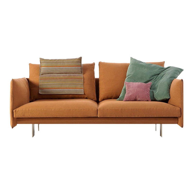 Orange sofa with textured green and pink accent pillows, featuring a striped pattern for aesthetic appeal.
