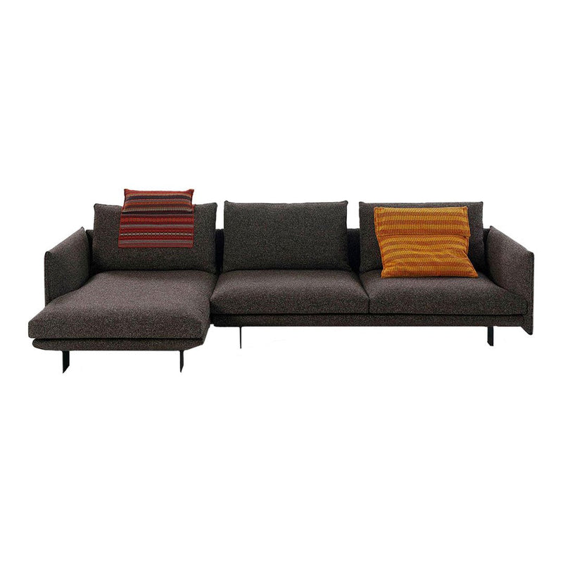 Modern gray sectional sofa with bold striped orange and red accent pillows. Stylish and contemporary design.