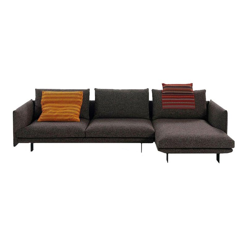 Modern dark grey sectional sofa with colorful striped accent pillows in orange and red. Elegant and stylish design.