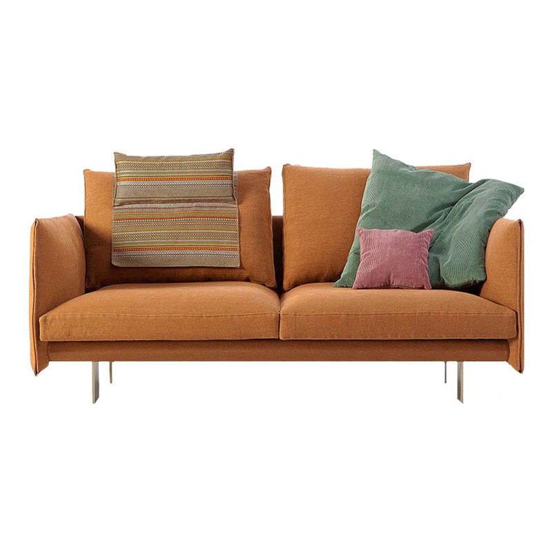 Modern orange sofa with mixed-pattern cushions in green and purple for a vibrant, cozy look.