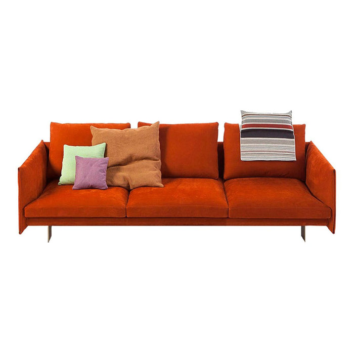 Vibrant orange sofa with colorful pillows in green, purple, and striped patterns, perfect for a stylish living space.