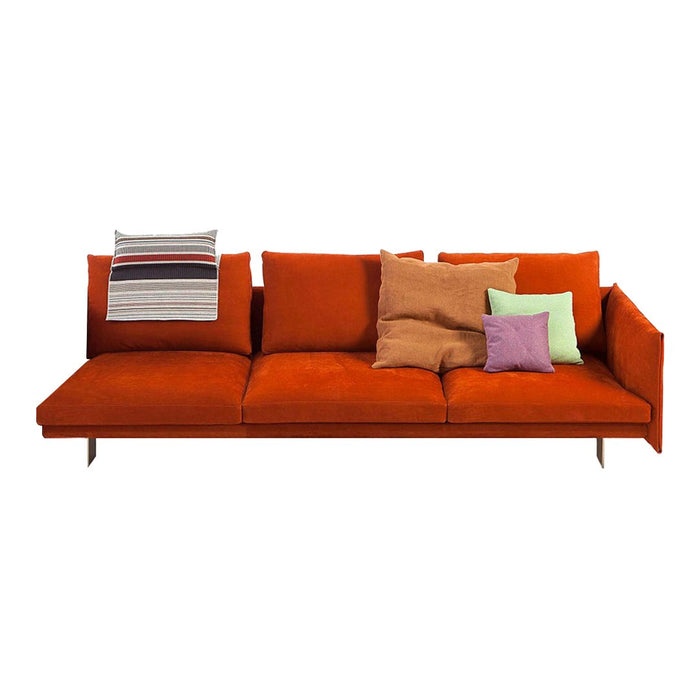 Vibrant orange sofa with assorted throw pillows in pastel and striped patterns, adding a pop of color and texture.
