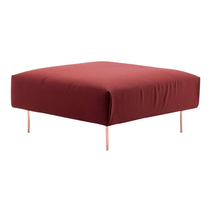 Square tufted ottoman in deep burgundy fabric with sleek pink legs, perfect for modern living spaces.