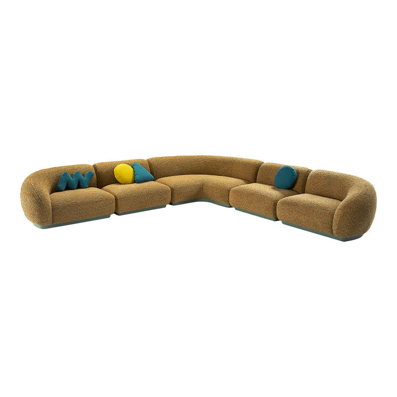 Curved sectional sofa in earthy tones with textured fabric, featuring teal and yellow accent pillows.