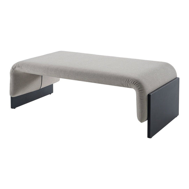 Stylish gray upholstered coffee table with sleek black legs, featuring a minimalist design and modern patterns.