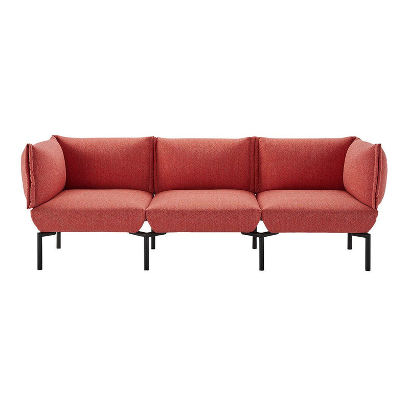 Red textured fabric sofa with three sections and black metal legs, featuring a modern, minimalist design.