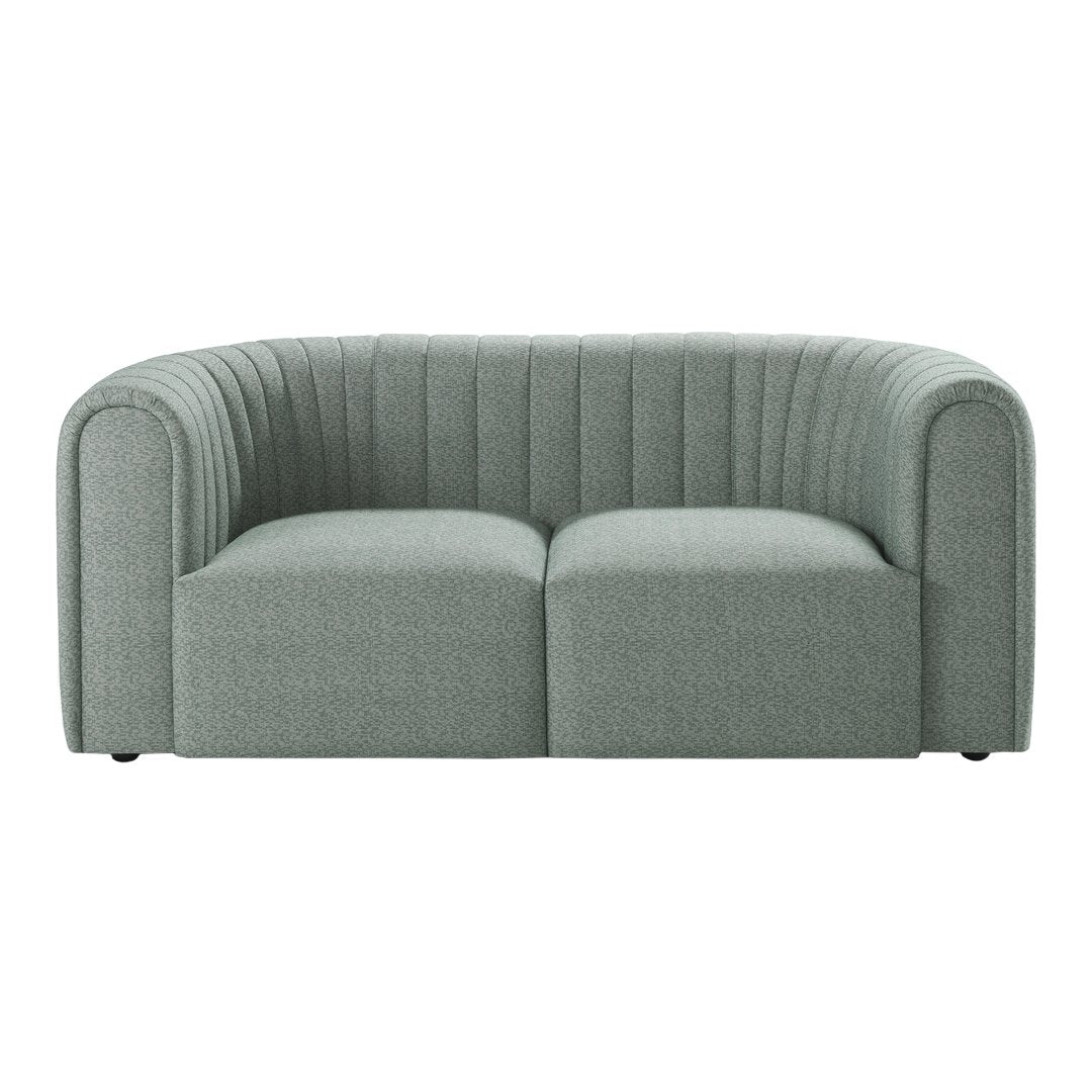 Light gray curved sofa with vertical ribbed texture and minimalist design, perfect for modern interiors.