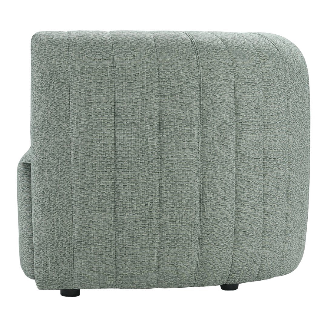 Soft green upholstery with textured, vertical ribbing pattern on a contemporary couch.