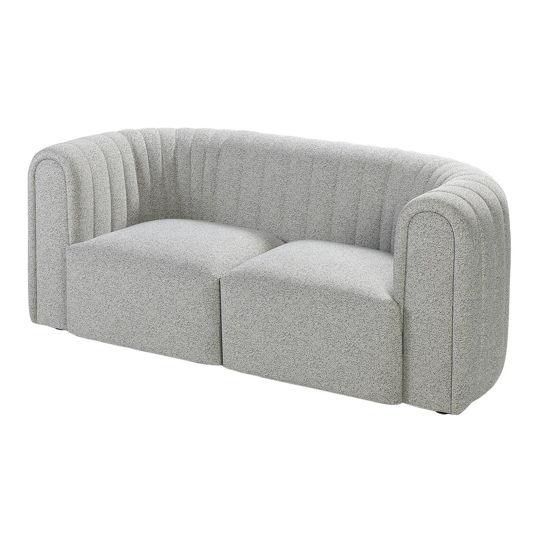 Light gray curved sofa with vertical ribbed pattern, featuring a modern and minimalist design.