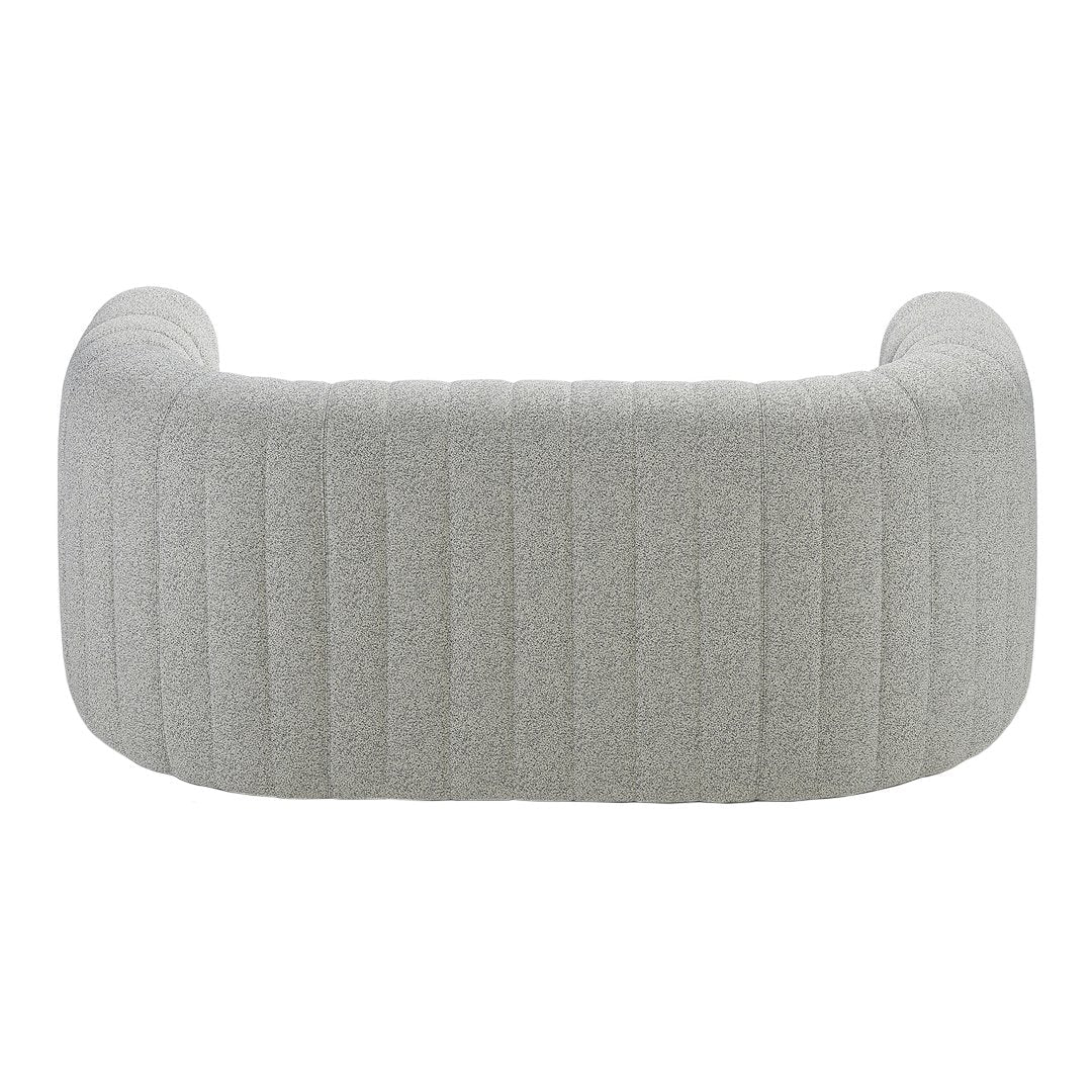 Soft gray upholstered couch with vertical ribbed pattern, creating a modern and stylish look. Perfect for contemporary decor.