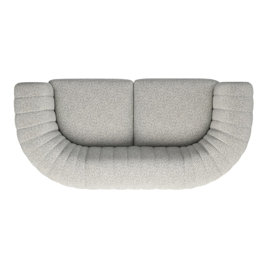 Curved light gray sofa with textured ribbed detailing, perfect for modern living spaces.