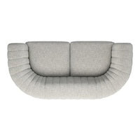 Curved light gray sofa with textured ribbed detailing, perfect for modern living spaces.