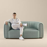 Stylish light blue couch with subtle ribbed pattern, perfect for modern interiors.