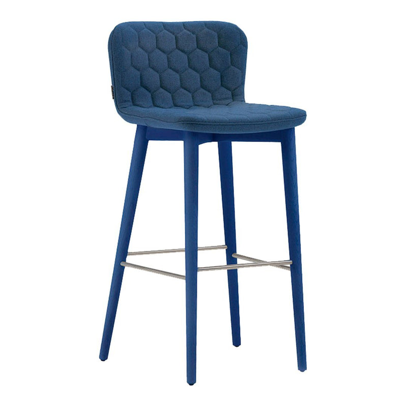 Blue bar stool with hexagonal pattern upholstery and matching legs, featuring a sleek metal footrest.