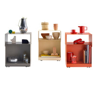Colorful modern side tables in gray, beige, and vibrant orange, featuring sleek lines and simple geometric designs.