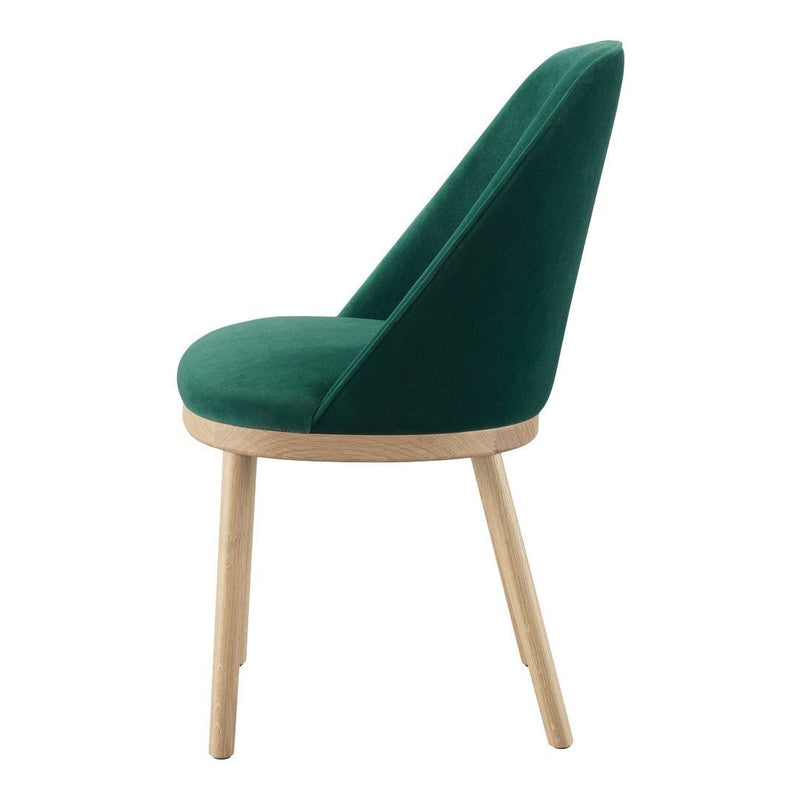 Green velvet chair with a sleek, modern design and light wood legs. Perfect for stylish interiors.
