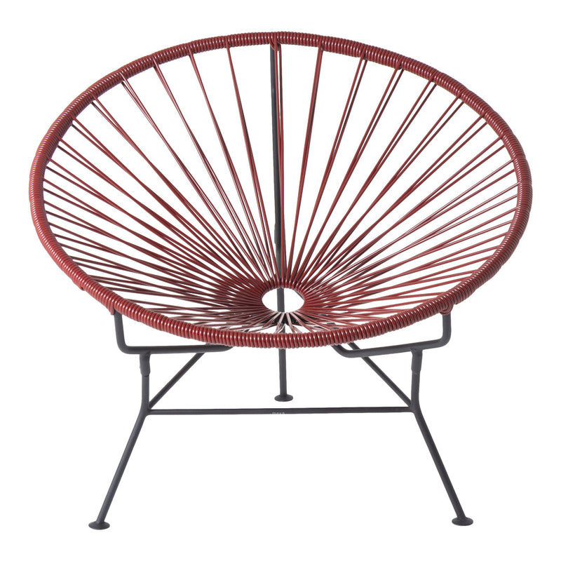 Red woven chair with a sunburst pattern and a black metal frame, perfect for adding a pop of color to any space.