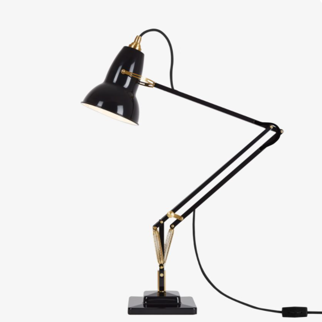 Black desk lamp with gold accents and a sleek, modern design, featuring a minimalist arm and base.