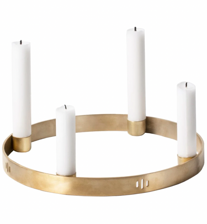 Golden candle holder with four white candles, featuring a sleek, modern design and minimalist aesthetic.