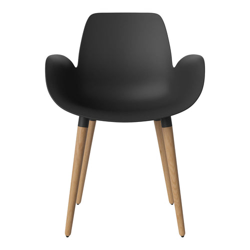 Black ergonomic chair with a smooth finish and natural wood legs, featuring a modern minimalist design.