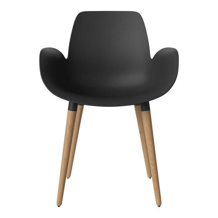 Black ergonomic chair with a smooth finish and natural wood legs, featuring a modern minimalist design.