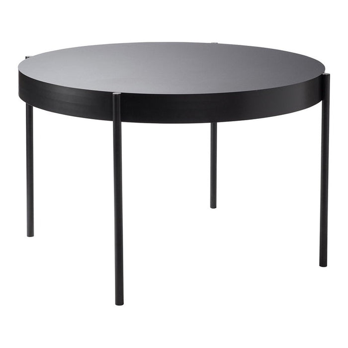Round black coffee table with a sleek, minimalist design and smooth surface, featuring four slender legs.