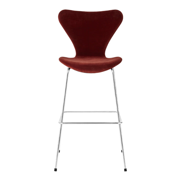 Red velvet bar stool with a sleek chrome base, showcasing a smooth, modern design. Ideal for stylish interiors.