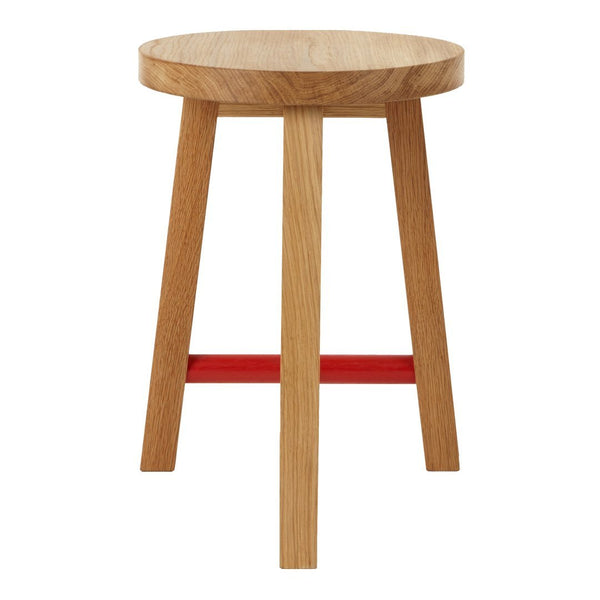 Natural wood stool with a round top and four legs, featuring a vibrant red horizontal support.