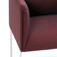 Textured burgundy upholstery on a modern chair, featuring clean lines and a sleek silver frame.