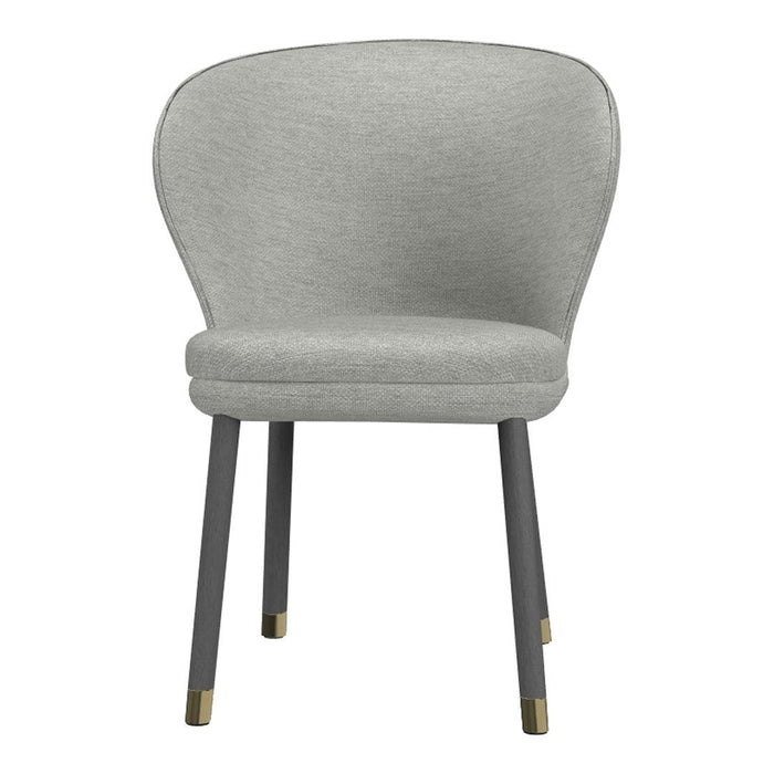 Light grey upholstered chair with smooth fabric, tapered black legs, and gold accents. Modern and minimalist design.