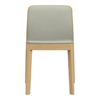 Mint green upholstered chair with natural wood legs, showcasing a minimalist design and a smooth finish.