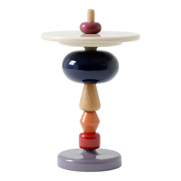 Colorful decorative table featuring a mix of navy, beige, orange, red, and lavender geometric shapes. Modern design accents.