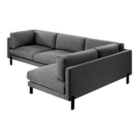 Modern gray sectional sofa with clean lines and plush cushions, featuring a minimalist design and sleek black legs.