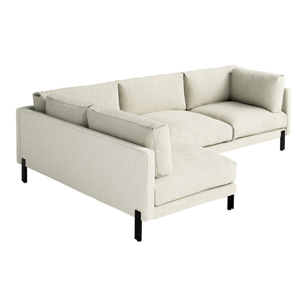 Light beige sectional sofa with a minimalist design and plush cushions, featuring black legs for contrast.