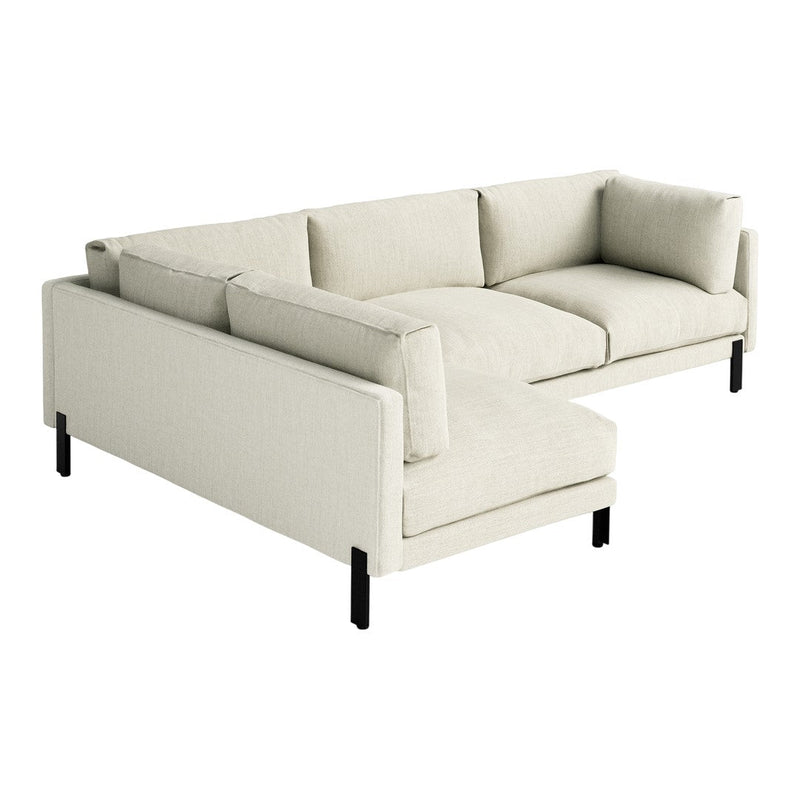 Light beige sectional sofa with a minimalist design and plush cushions, featuring black legs for contrast.