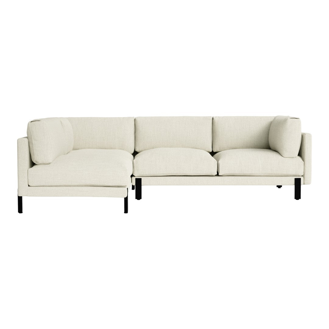 Cream-colored sectional sofa with a minimalist design and soft, textured upholstery, featuring sleek black legs.