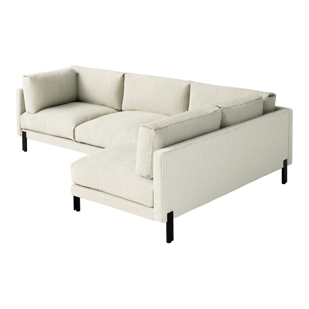 Light beige sectional sofa with soft, textured upholstery and sleek black legs. Minimalist design for modern decor.