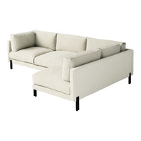 Light beige sectional sofa with soft, textured upholstery and sleek black legs. Minimalist design for modern decor.