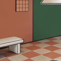 Colorful green and terracotta walls with checkerboard floor in shades of cream and burnt orange, creating a vibrant interior.