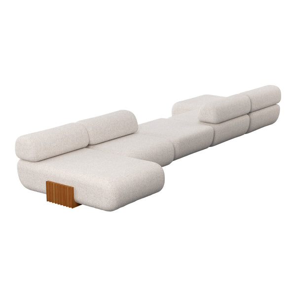 Light beige upholstered sectional sofa with smooth, modern lines and a textured finish.