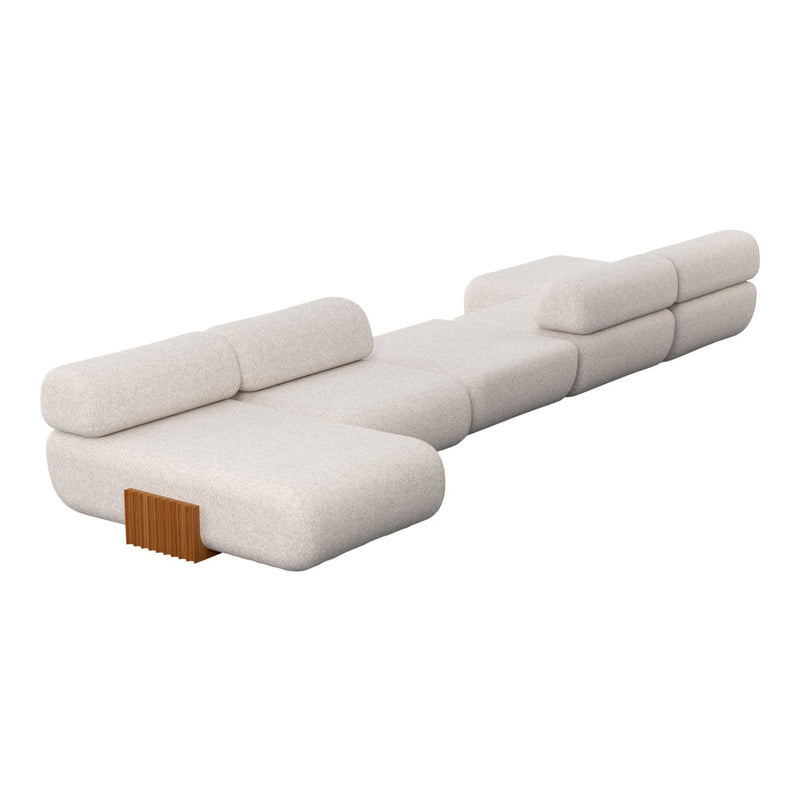 Light beige upholstered sectional sofa with smooth, modern lines and a textured finish.