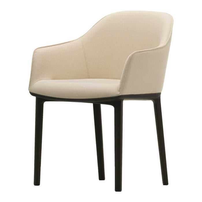 Beige upholstered chair with smooth curves and dark wooden legs, showcasing minimalist elegance and modern style.