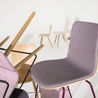 Modern chairs in soft lavender, light beige, and natural wood tones, showcasing sleek, minimalist designs and varied textures.