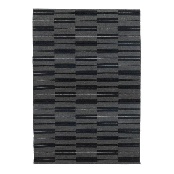 Gray area rug featuring a modern striped pattern in varying shades of black and charcoal. Perfect for contemporary spaces.