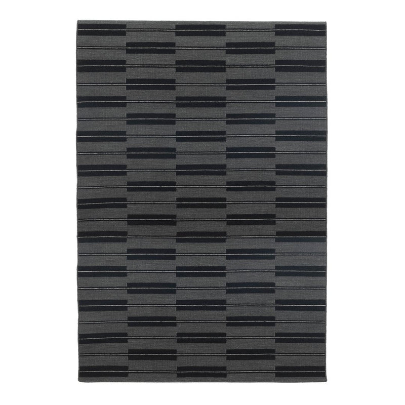 Gray area rug featuring a modern striped pattern in varying shades of black and charcoal. Perfect for contemporary spaces.