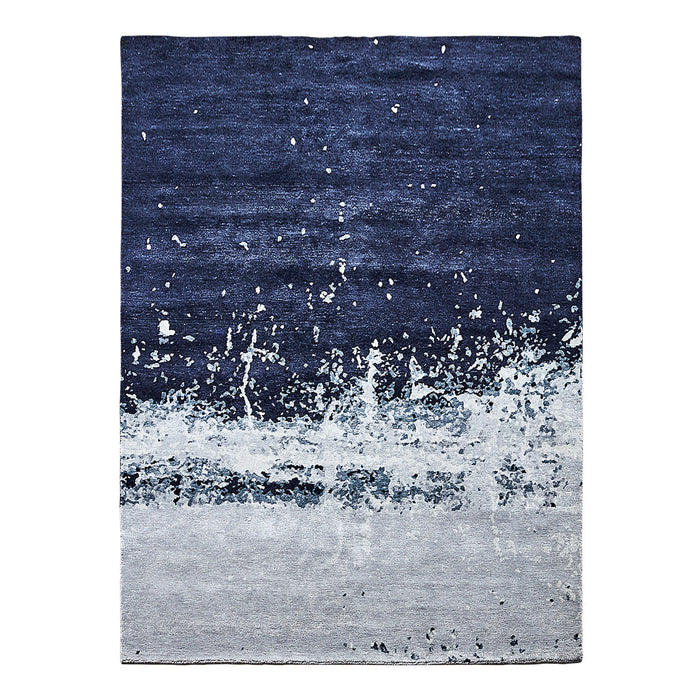 Navy blue and gray abstract area rug with a textured pattern and splashes for a modern touch.