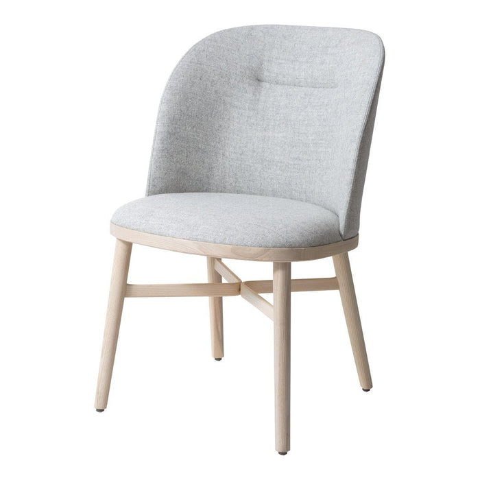 Gray fabric dining chair with a smooth finish and natural wood legs, featuring a minimalist design and soft curves.